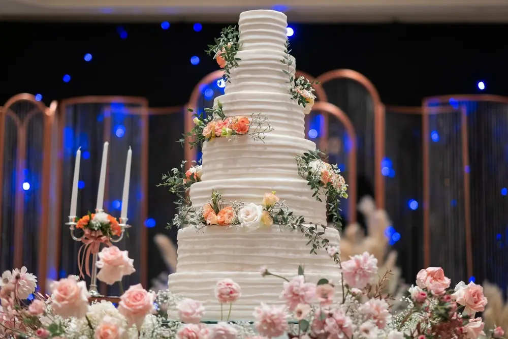 Stunningly gorgeous wedding cake on a bed of flowers at Kirkbrae country club in Rhode Island