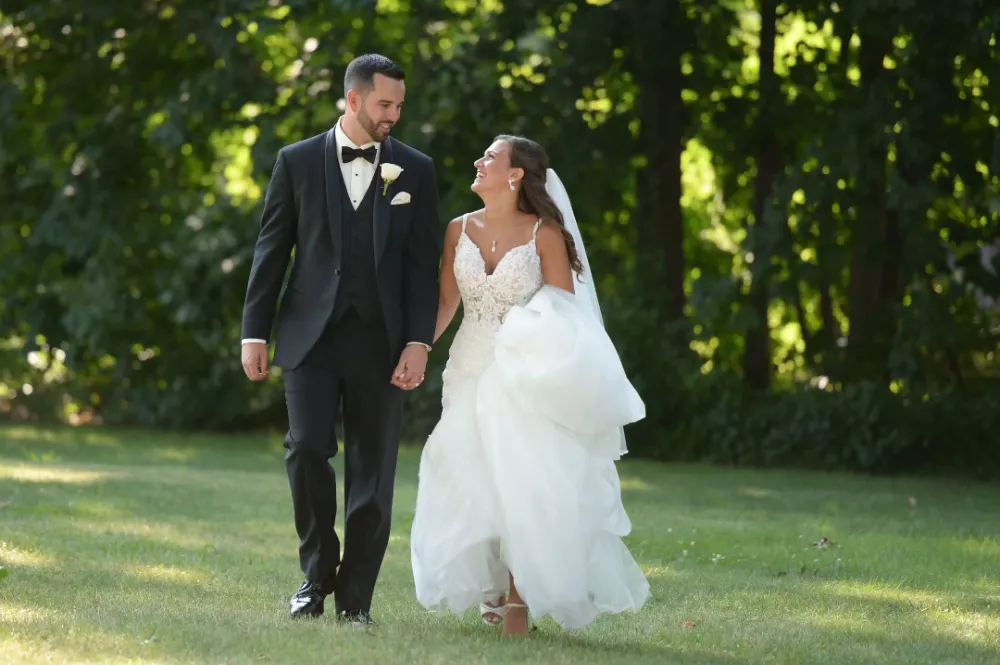 Bride and groom walking the grounds of Kirkbrae Country Club after their Rhode Island wedding