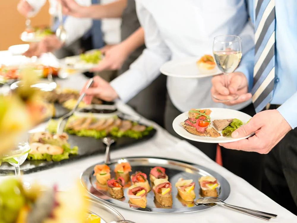 Company lunch featuring employees enjoying a catered corporate luncheon