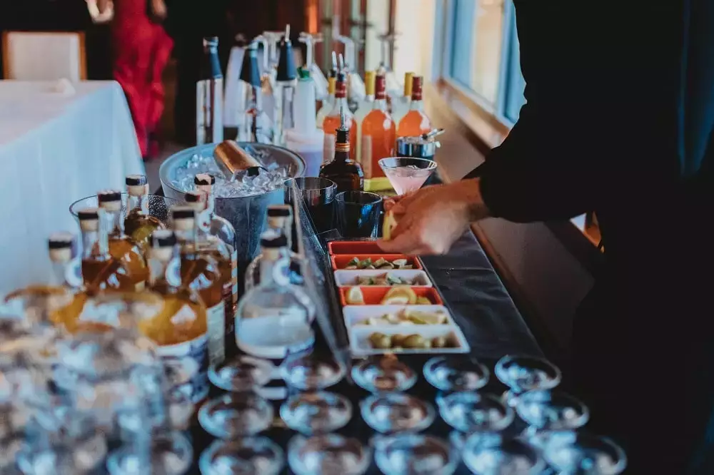 Bartender mixing martinis for wedding guests at wedding venue
