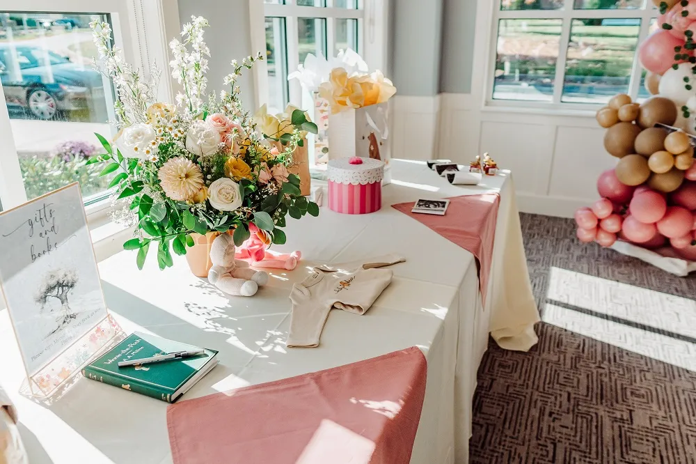 Ornately decorated table in the Charcoal Room at Kirkbrae CC for an upcoming baby shower
