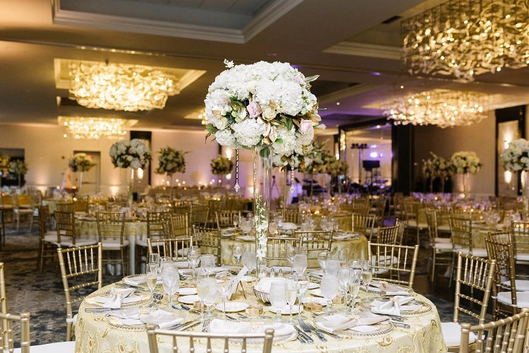 Beautifully decorated floral arrangement as centerpiece on wedding table as designed by Kirkbrae's wedding planners