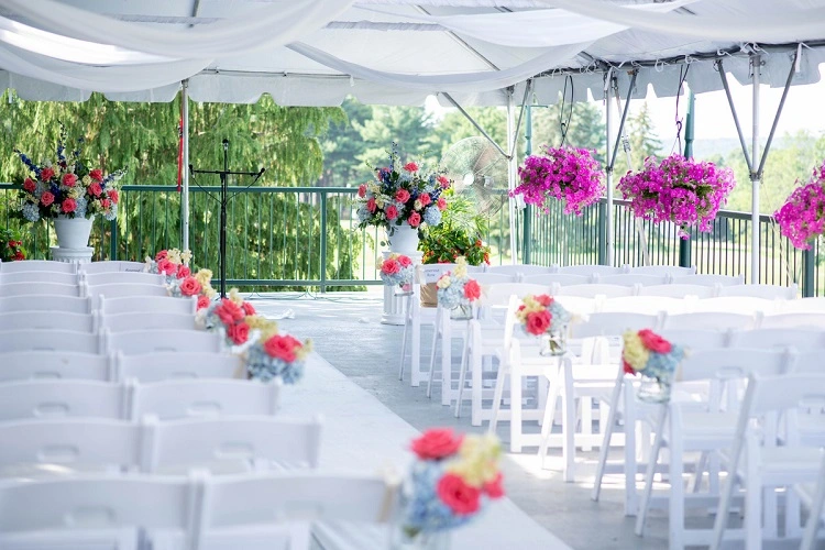 White chairs set up at an outdoor wedding venue