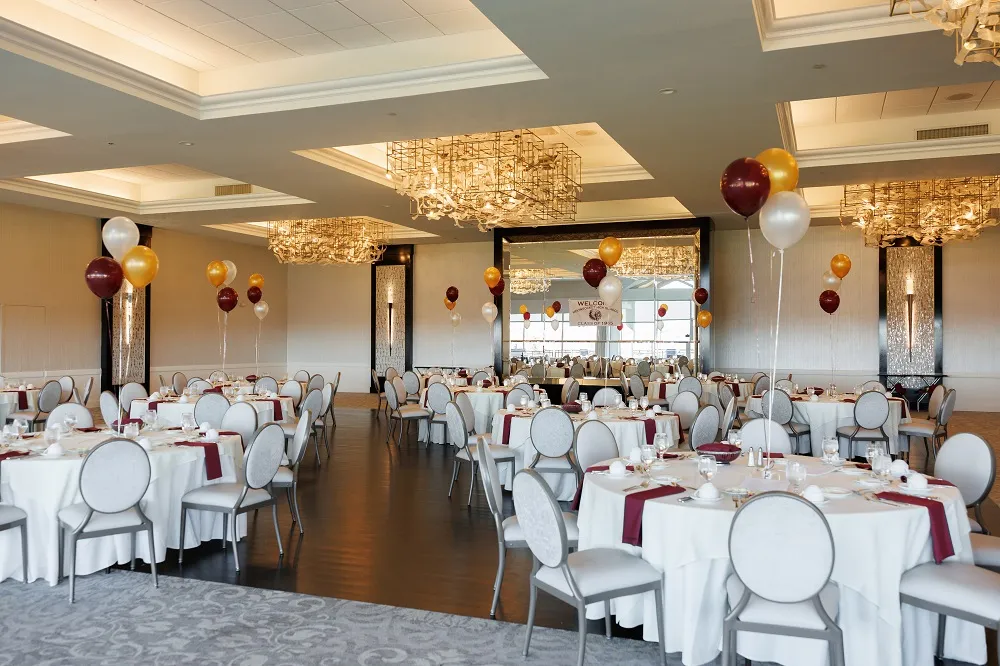 birthday party event venue setup with gold and red balloons