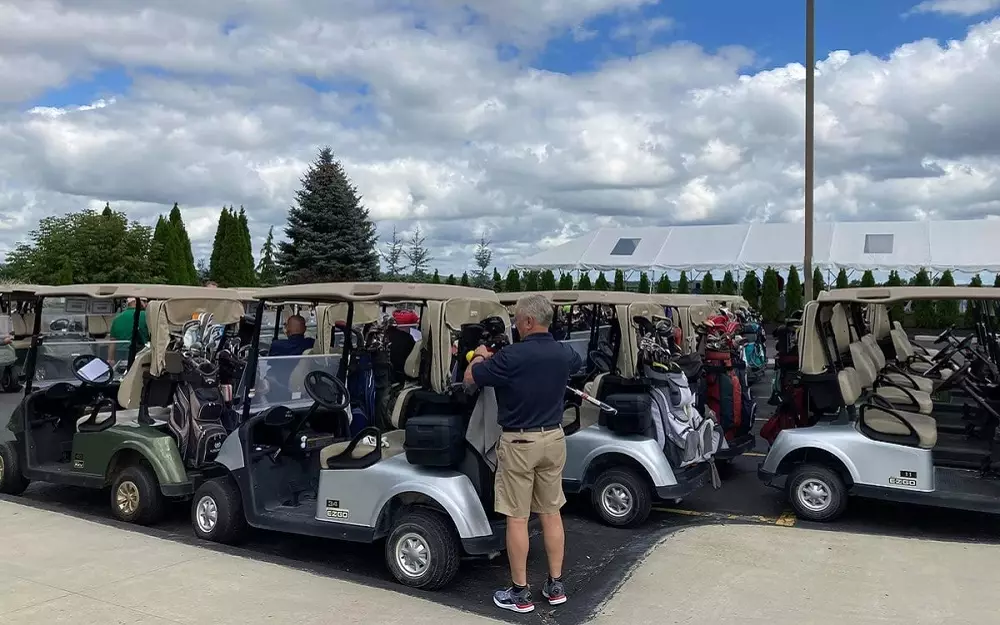 Golf carts lined up ready to tee off for a golf outing