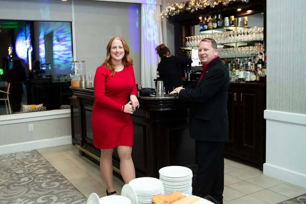 Two people talking at a bar at a nonprofit gala at Kirkbrae Country Club