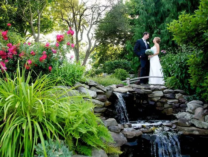 Bride and Groom getting married outdoors in the gardens of Kirkbrae Country Club