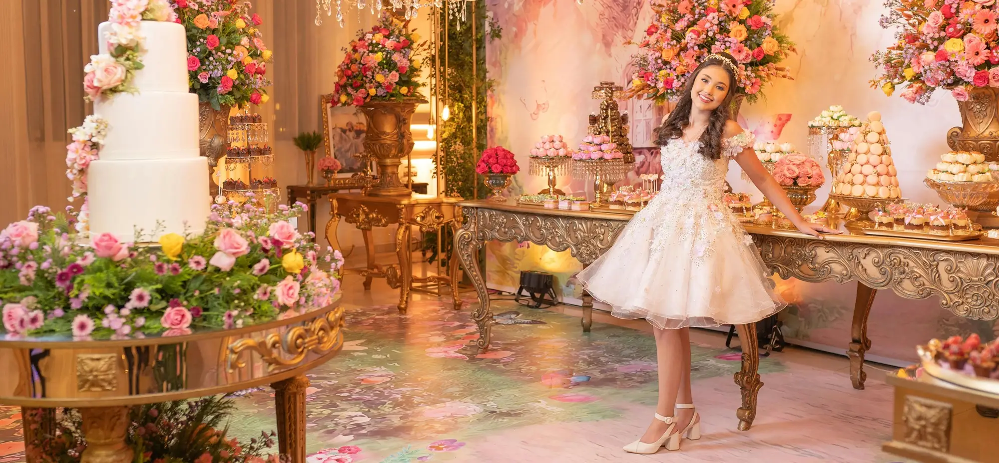 a 15 year old hispanic girl at her quinceanera at Kirkbrae Country club in rhode island standing in front of beautiful quinceanera decor