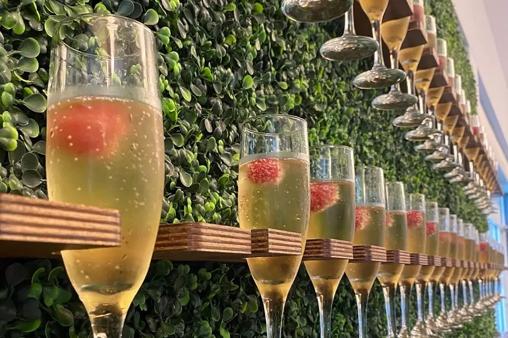 Champagne glasses lined up on wall