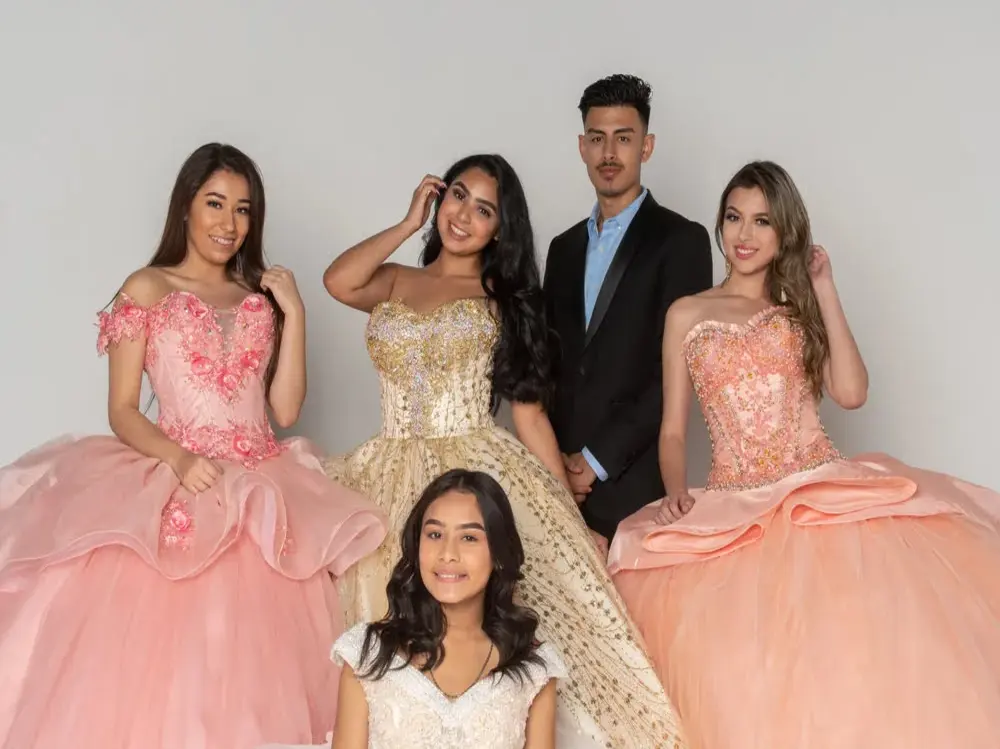 Quinceanera history and traditions featuring a court of honor in formal gowns and attire
