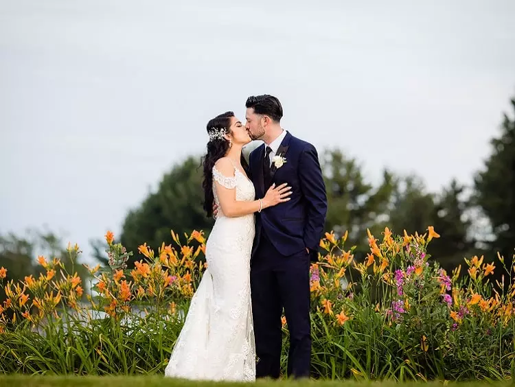 Bride and groom kissing at our outdoor wedding facility