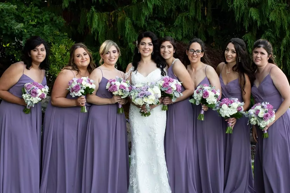 Bride and bridesmaids wearing purple dresses